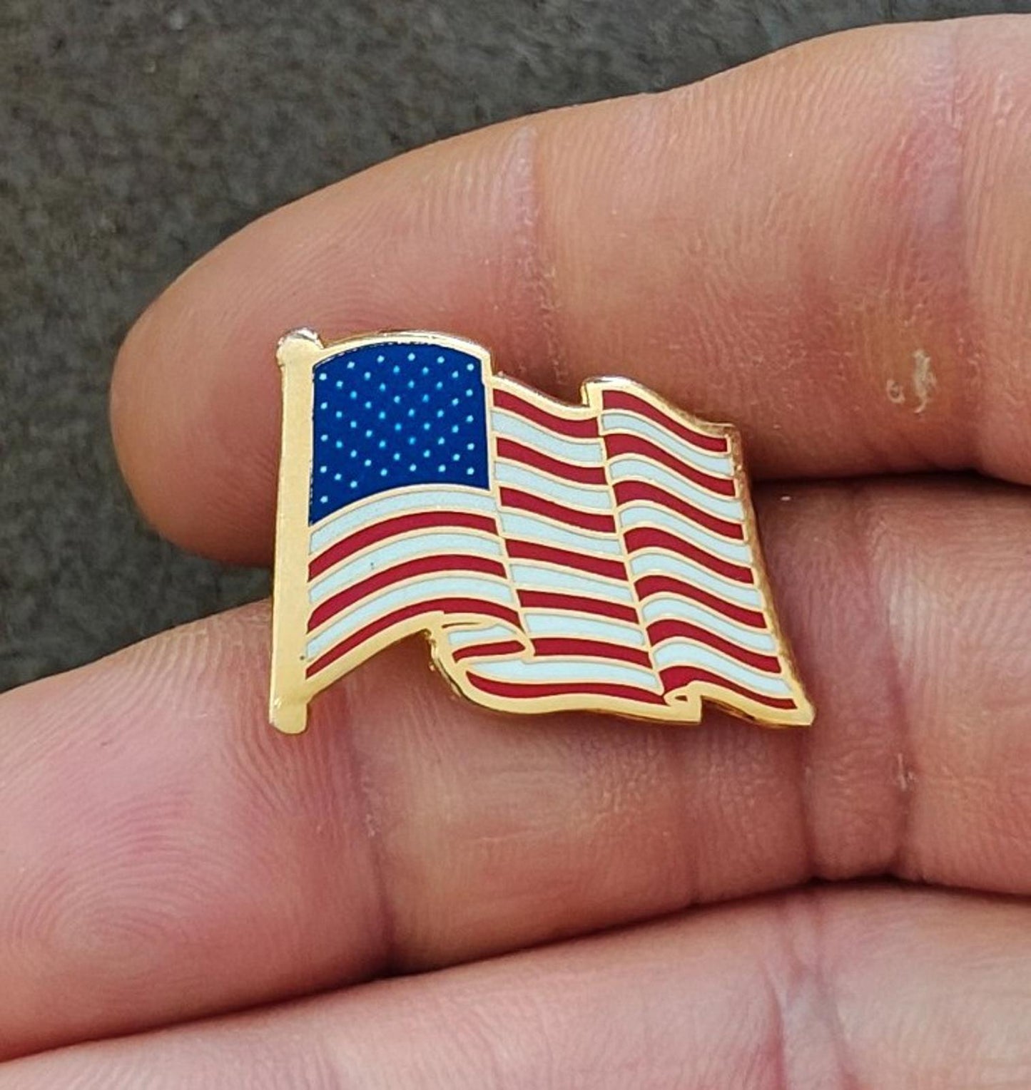 1980s Patriotic Gold Tone Enameled American Wavy Flag Pin.