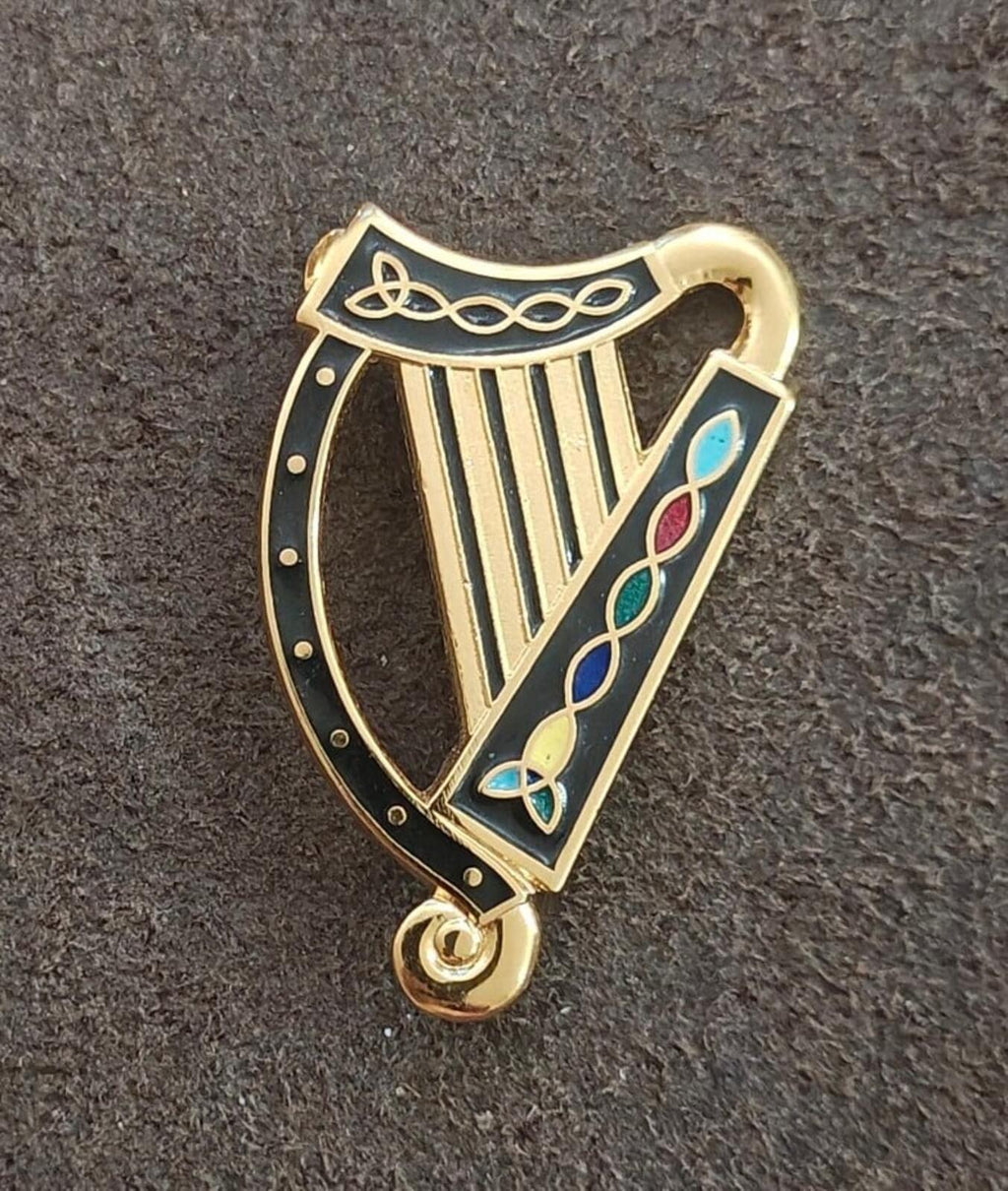 Gold-tone Irish harp pin with black enamel edge and blue floral enamel accents