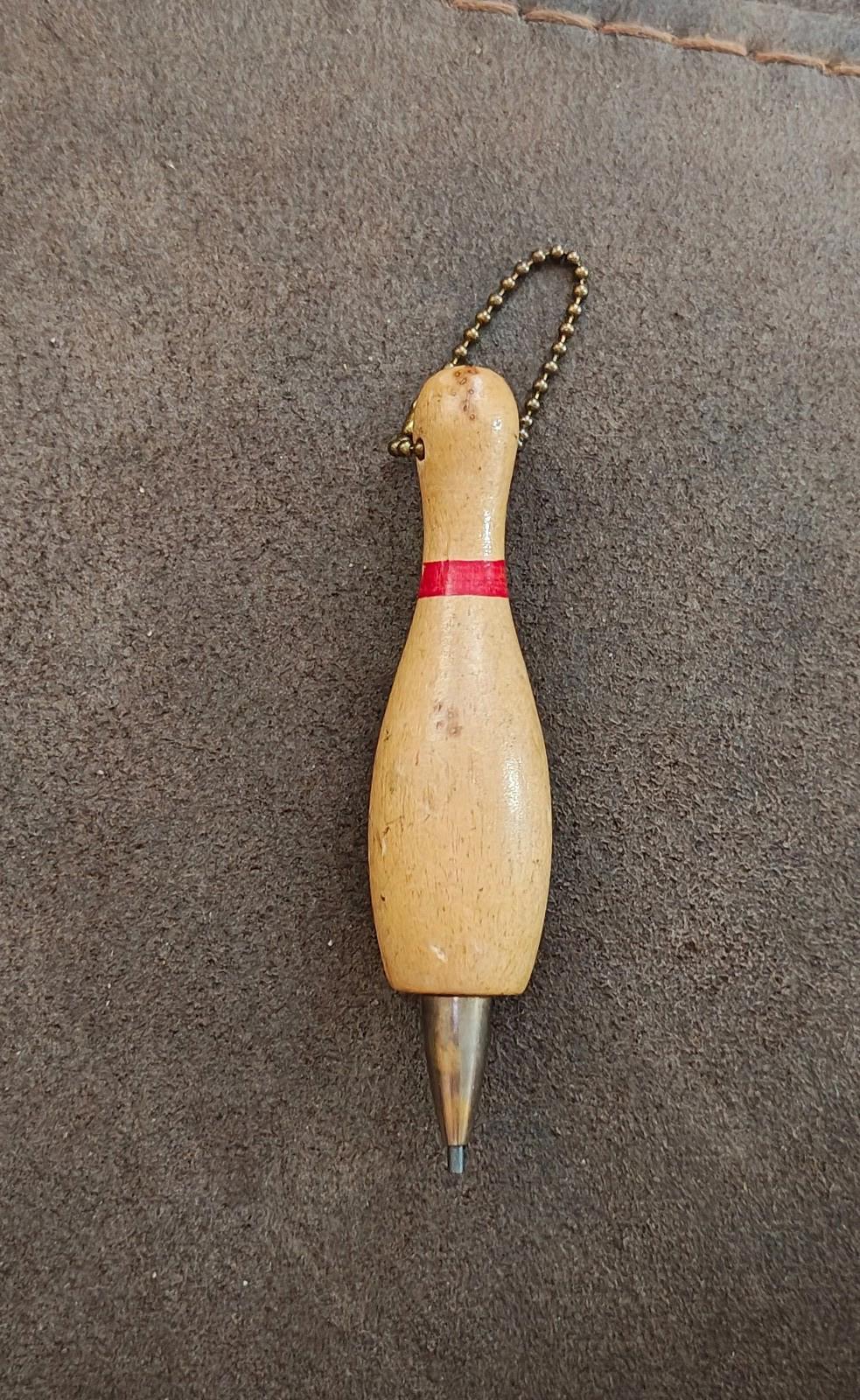 Beige wooden bowling pin mechanical pencil keychain with red band, bead chain, and metal tip