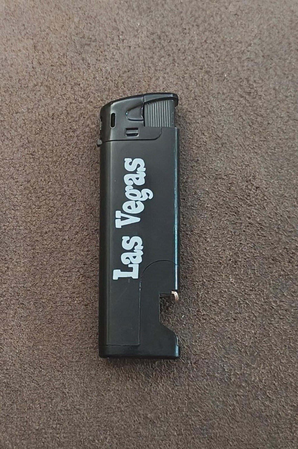 Black Las Vegas refillable bottle-opener lighter with flip-top and thumb grip
