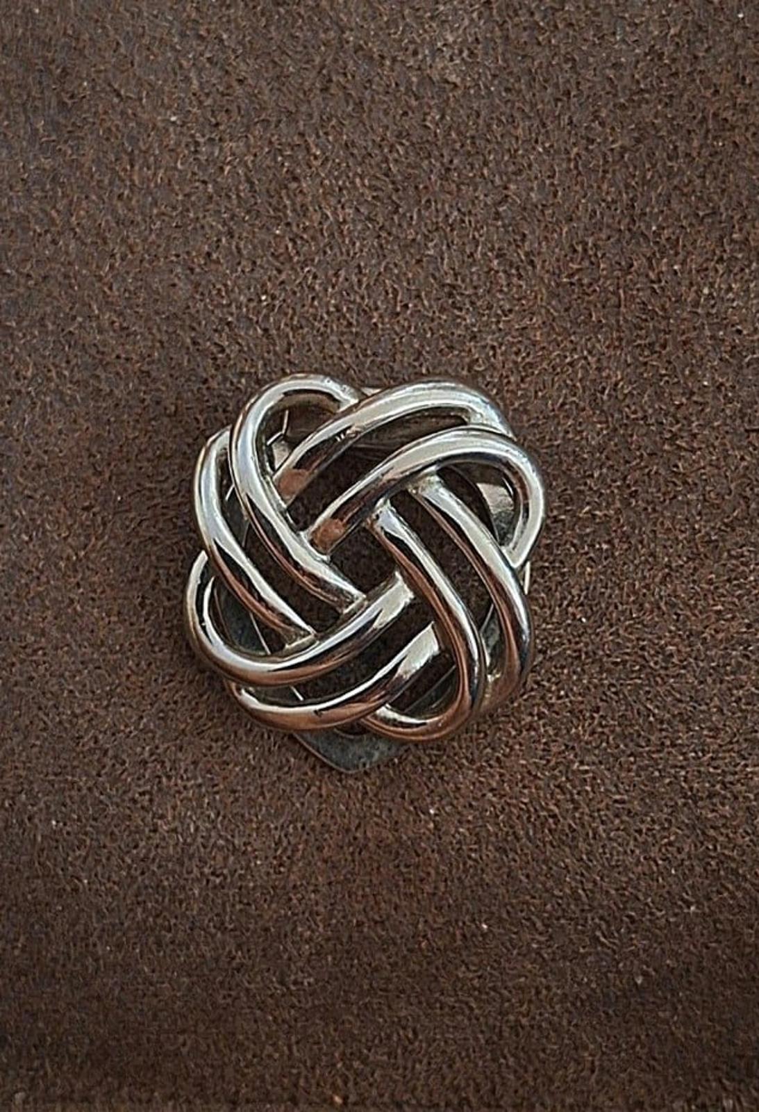 Silver love-knot scarf clip, front view of braided metal loops