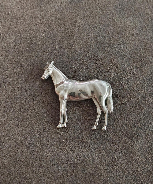 Silver-tone horse brooch, small standing horse design on textured background