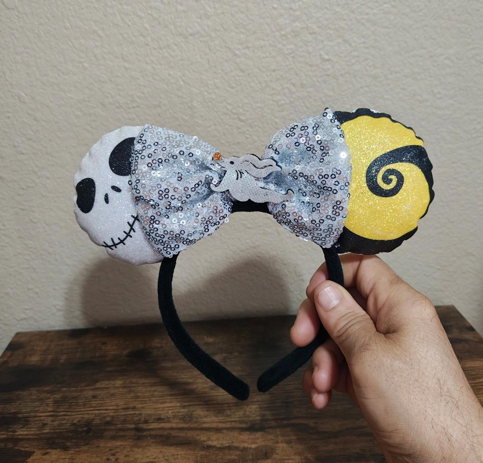 Silver sequin bow headband with black headband band and yellow spiral ear