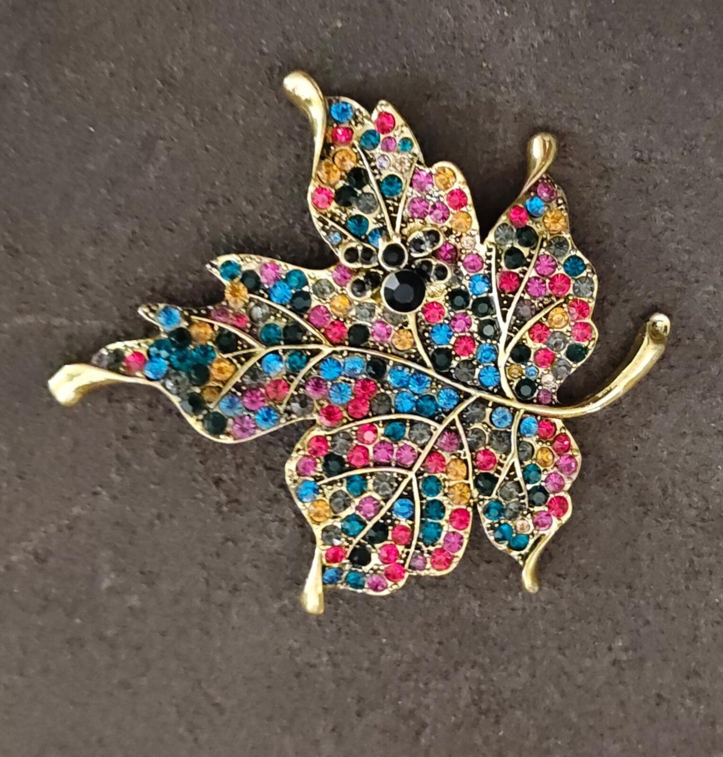 1980s Gold Tone Maple Leaf With Multi Colored Rhinestones Brooch