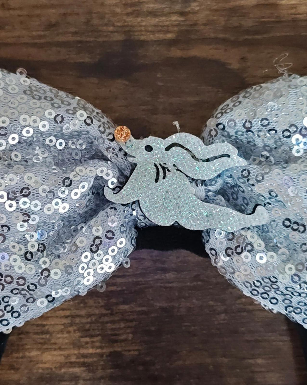 Silver sequin bow center with blue-gray cloud patch and stitched cloud motif