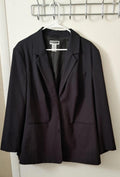 Black blazer with notched lapels, button front, and flap pockets.