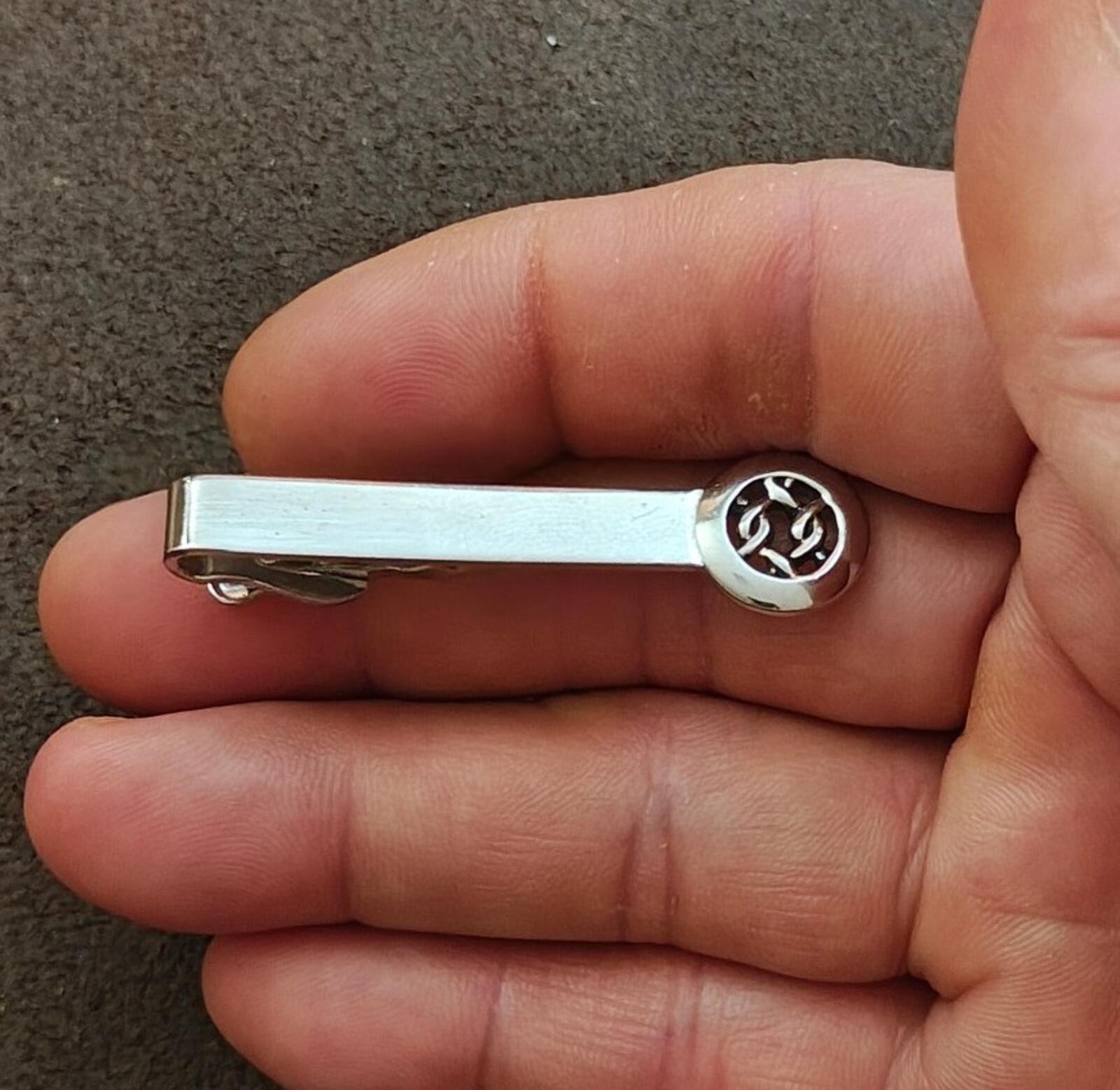 Silver tie bar clip with round Celtic knot end and hinged bar back