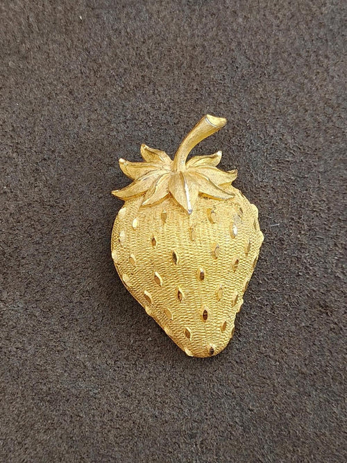 Gold tone strawberry brooch pin, front view with leaf and dotted seed detail.