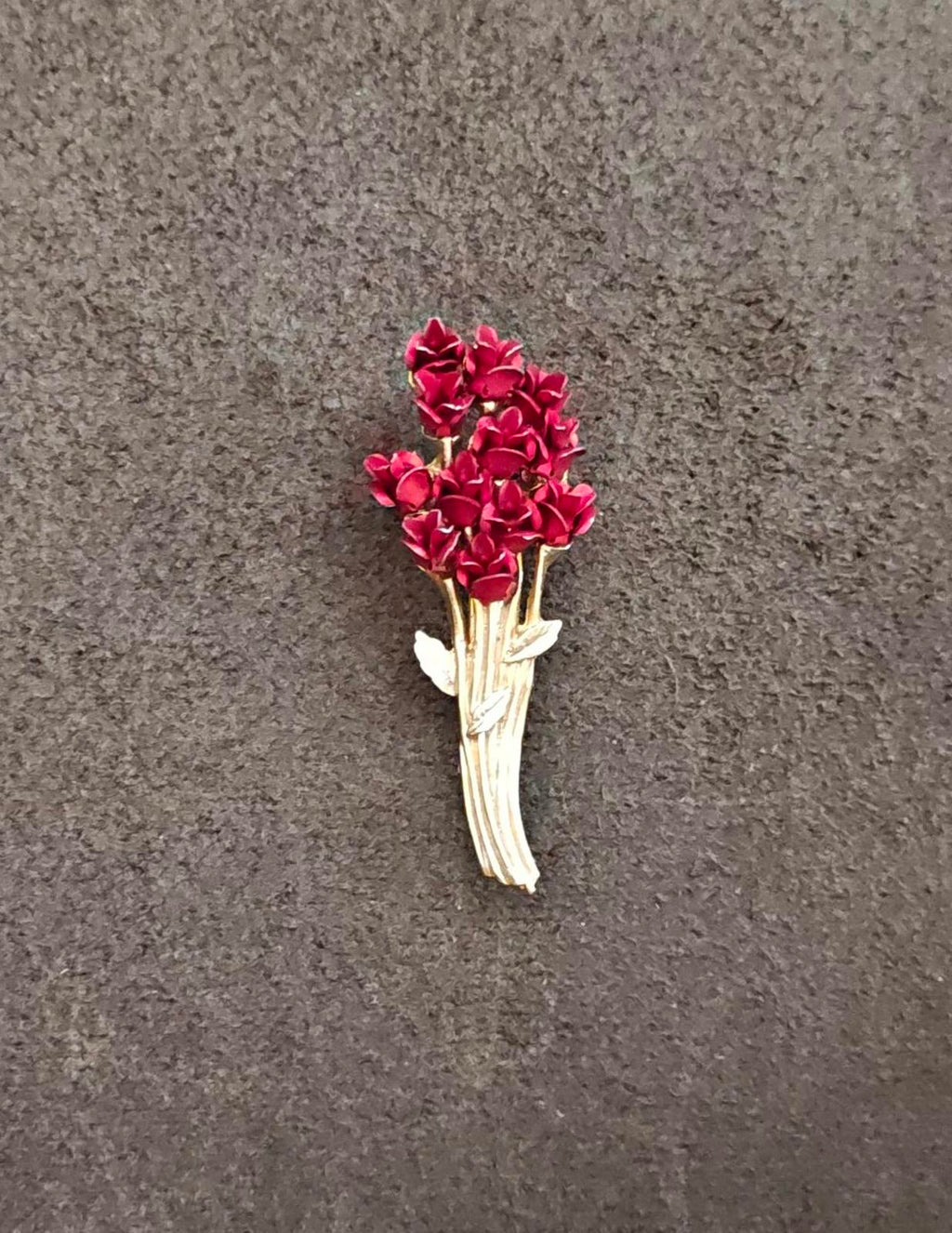 Gold tone rose bouquet brooch with red flower clusters and gold ribbon stem