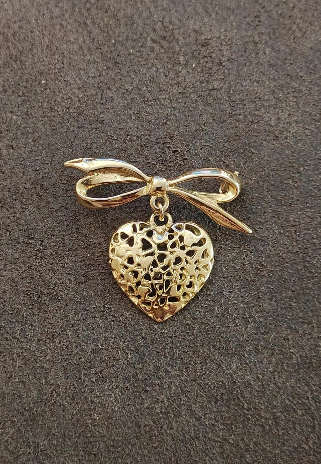 80s Gold Tone Ribbon Bow Brooch With a Dangling Openwork Filigree Heart Pendant
