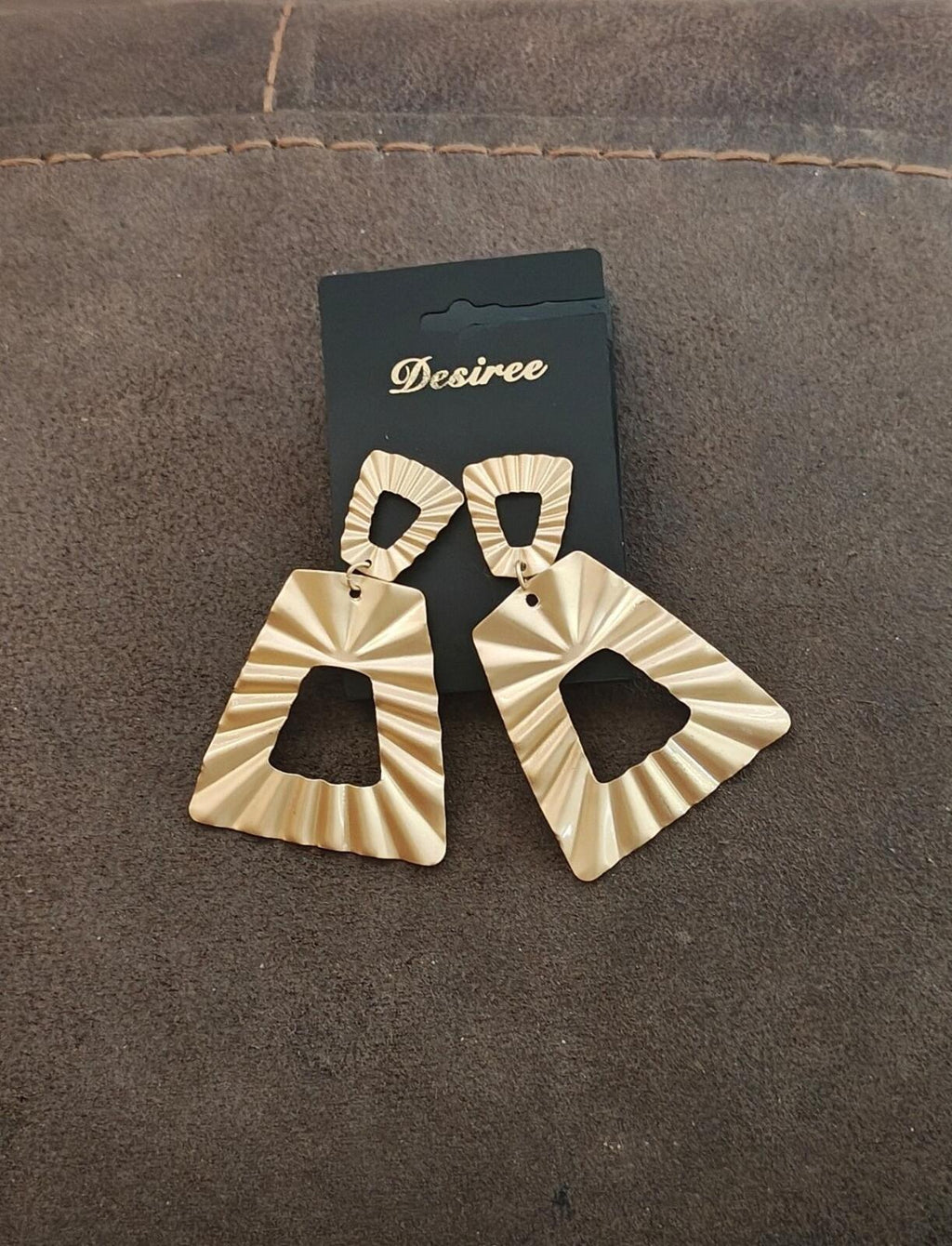 Gold tone hammered statement earrings with black top studs and sculpted triangular fans
