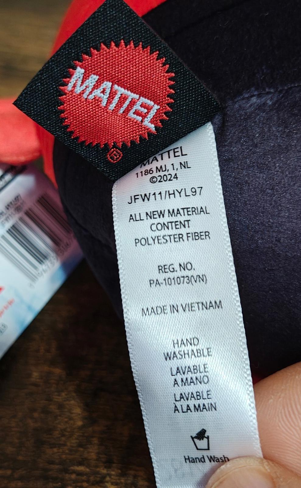 Close-up of plush care label: hand washable, all new material, made in Vietnam