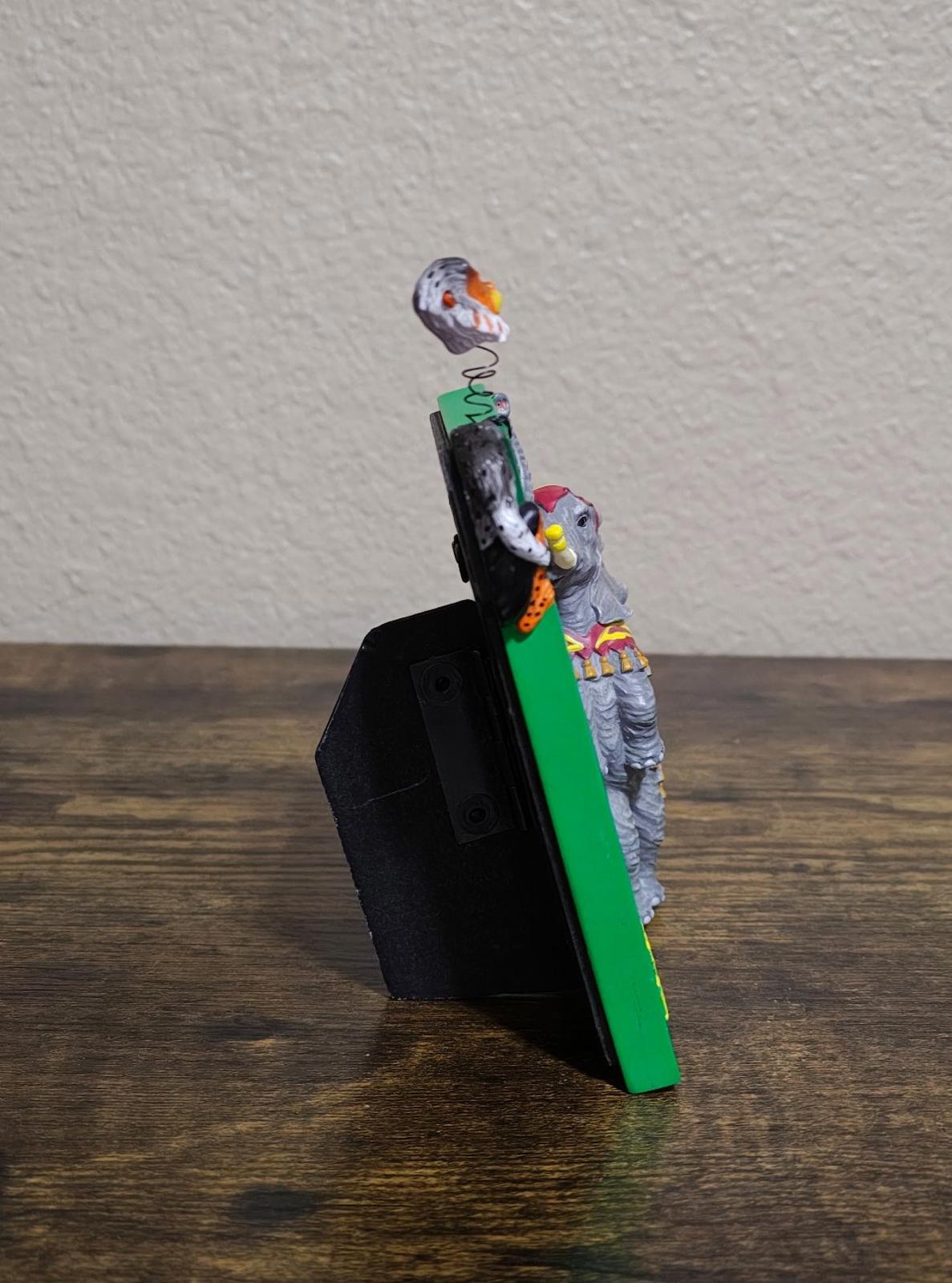 Green souvenir photo frame back angle with elephant and monkey standing on edge
