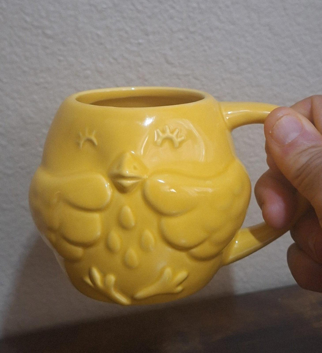 Yellow ceramic mug with 3D chick embossing and rounded handle