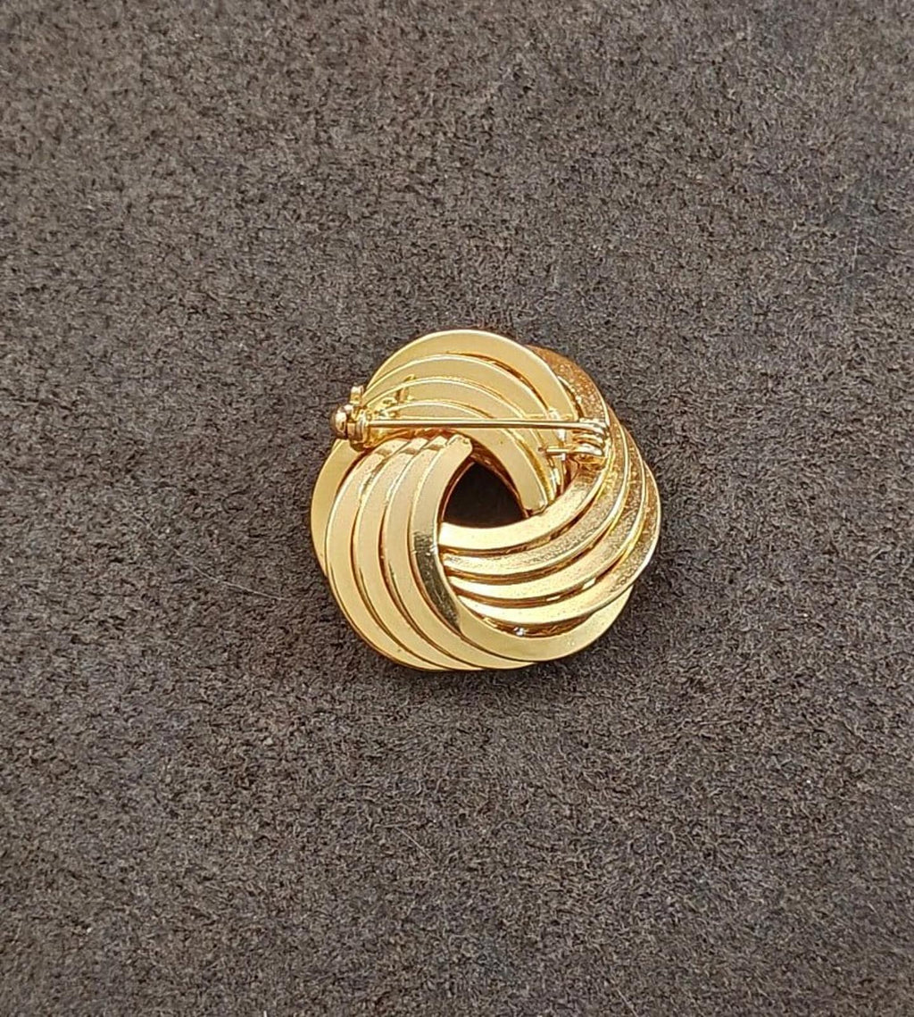 Gold tone back of swirl brooch pin with pin stem and clasp mechanism