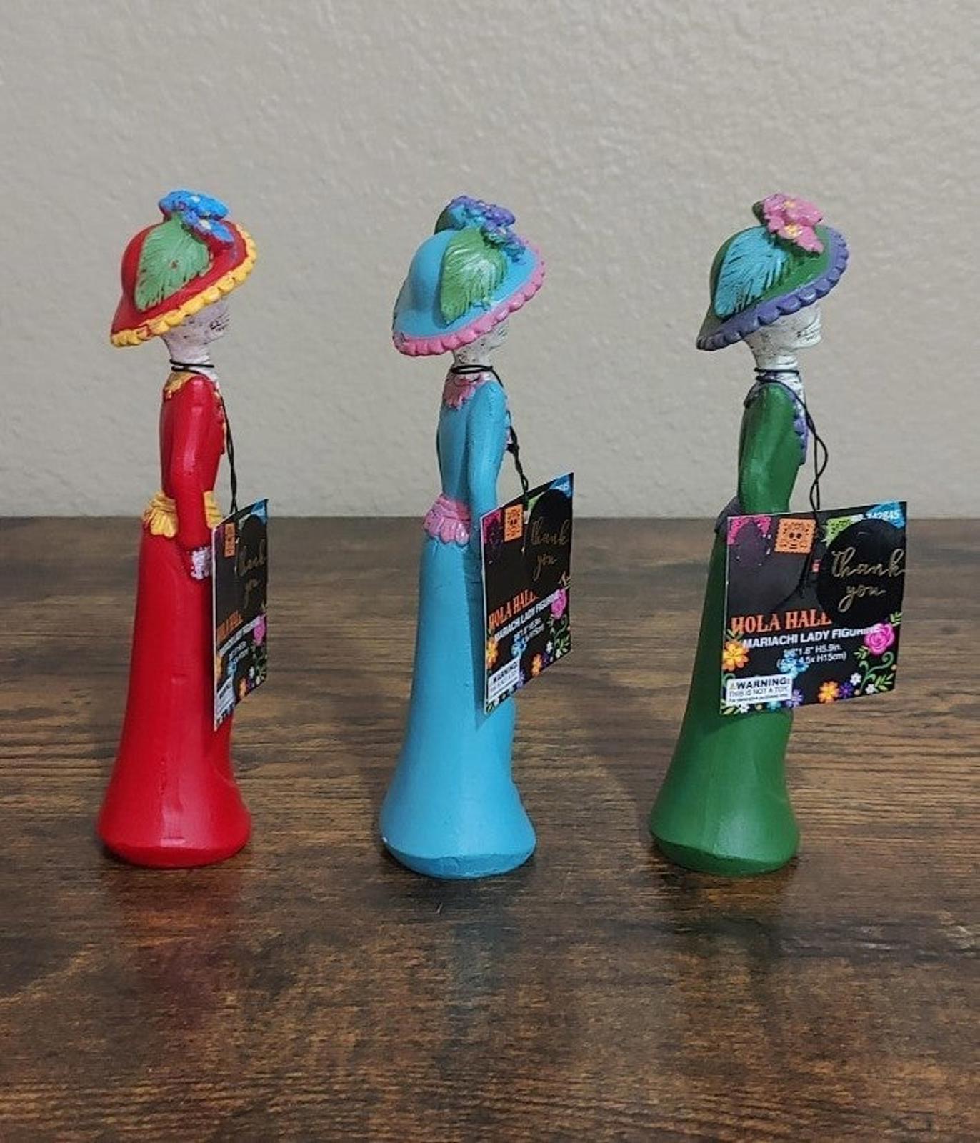 Set of three Day of the Dead lady figurines in red, blue, and green, back side views
