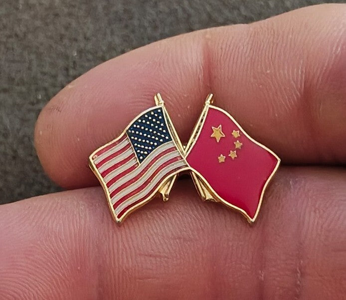 Gold tone enamel lapel pin with crossed US and China flags, red and pink enamel.