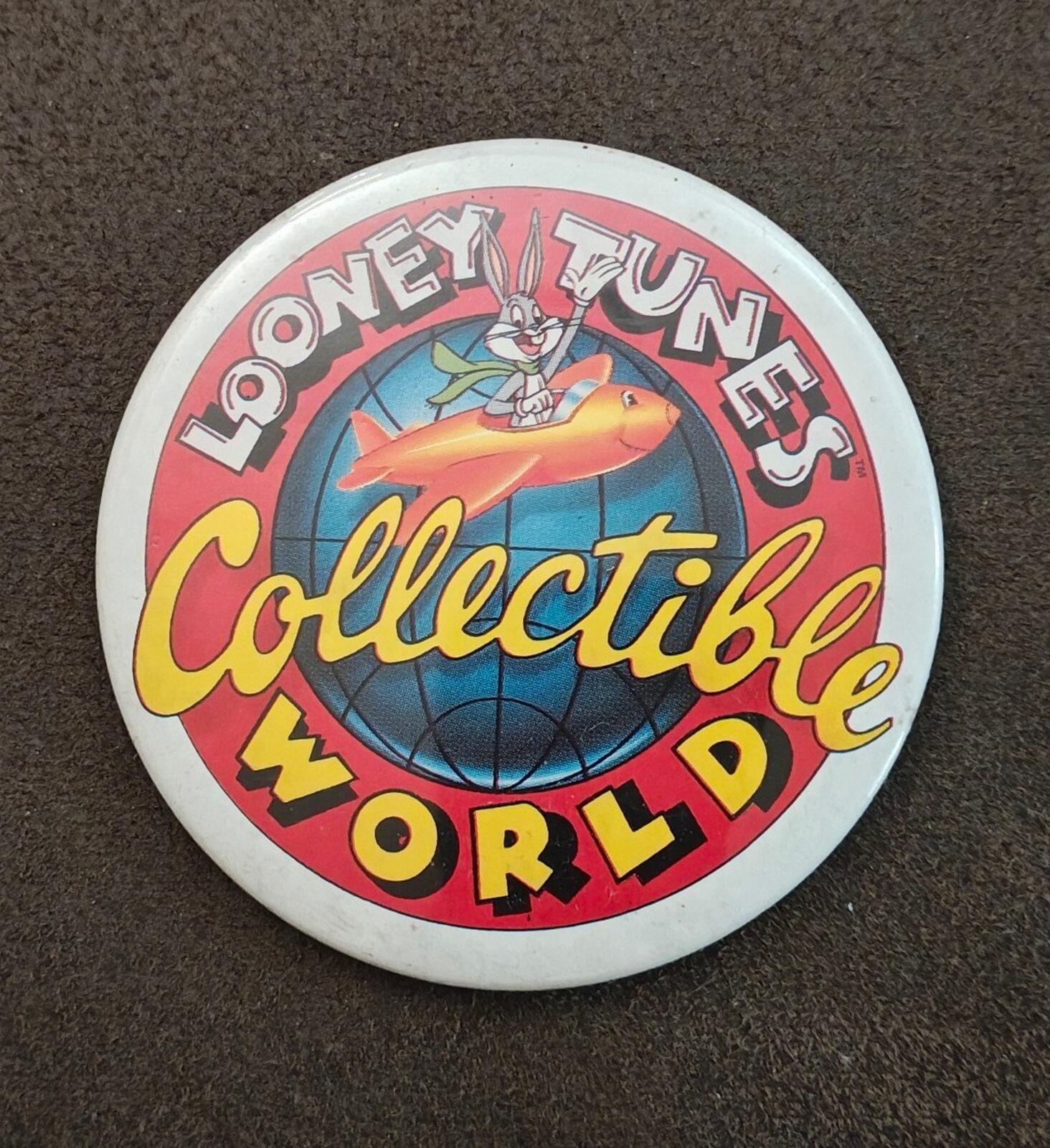 Round Looney Tunes “Collectible World” button pin featuring globe, rocket character, and bold text.