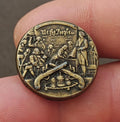 Gold-toned circular pin with 'We the People' inscription and constitution signing scene
