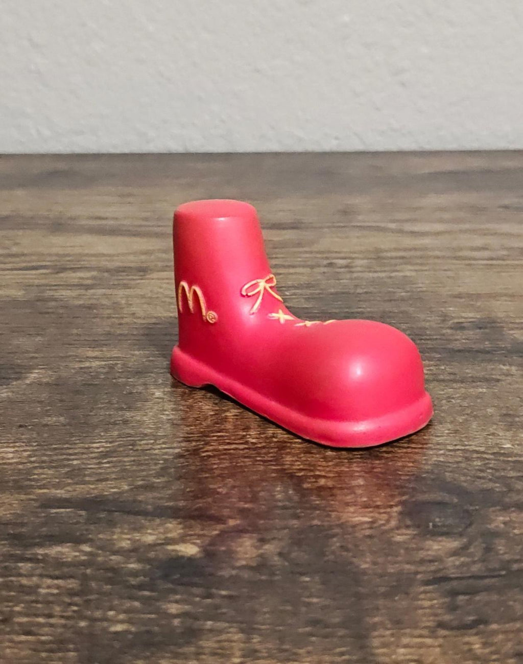 Red shoe antenna topper figurine three-quarter view with gold McDonald's logo