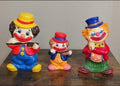 Vintage clown coin bank set, three colorful figurines standing side by side