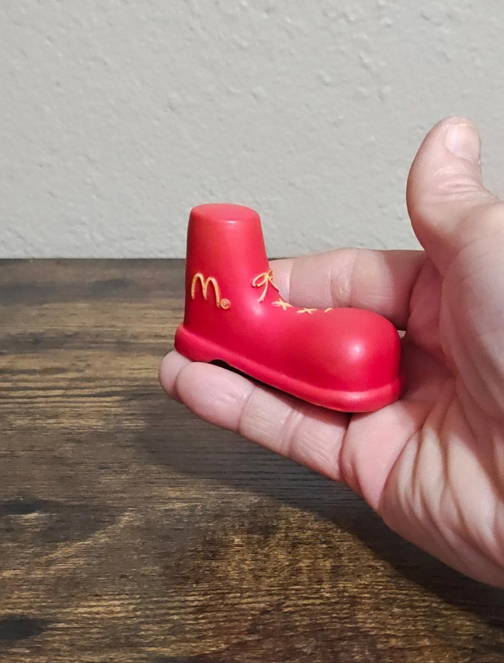 Red shoe antenna topper figurine shown from side, with gold McDonald's logo