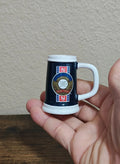 Handheld dark blue mini mug with white handle, 'World Series' crest logo on front.