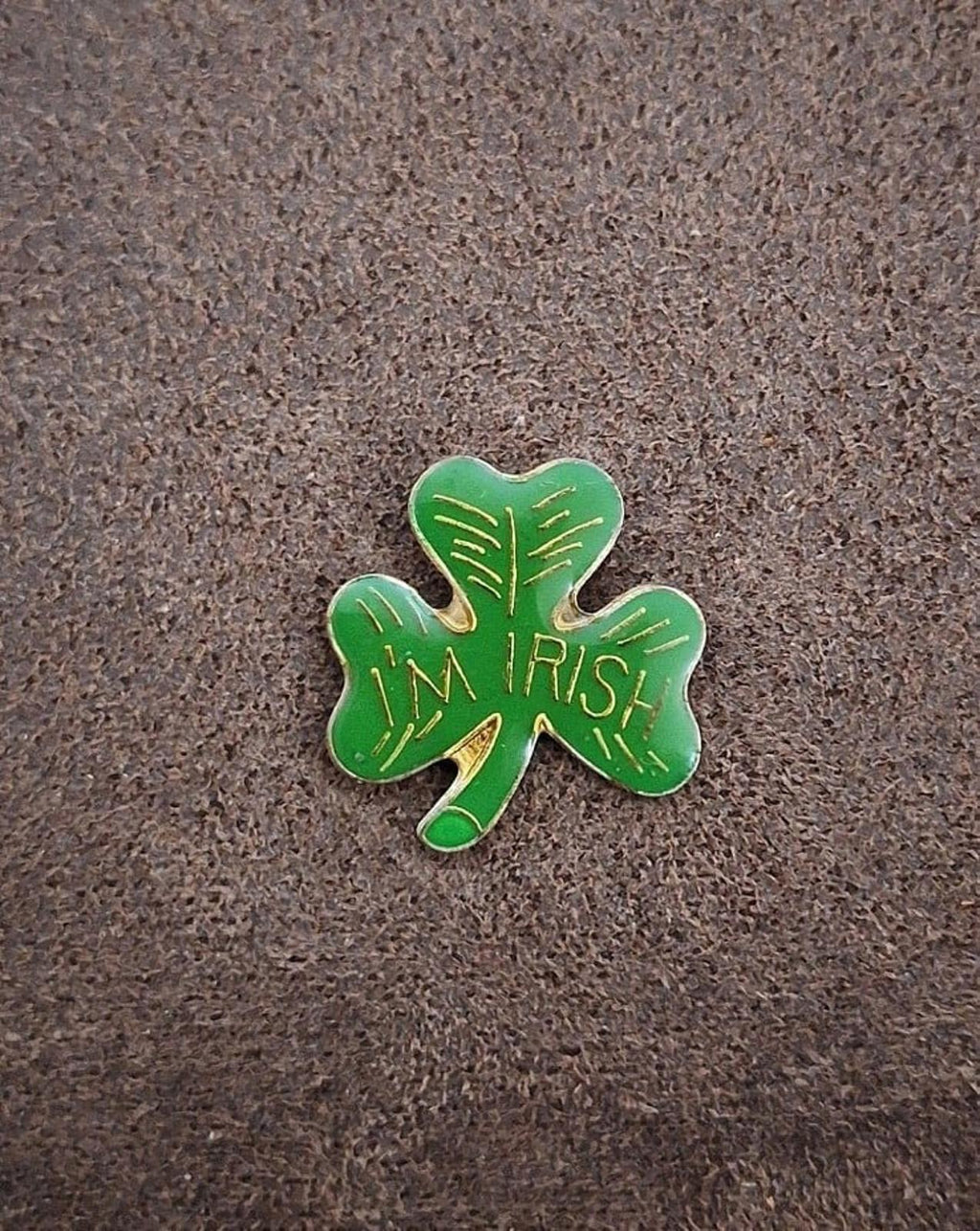 Green enamel shamrock pin with gold “IRISH” text