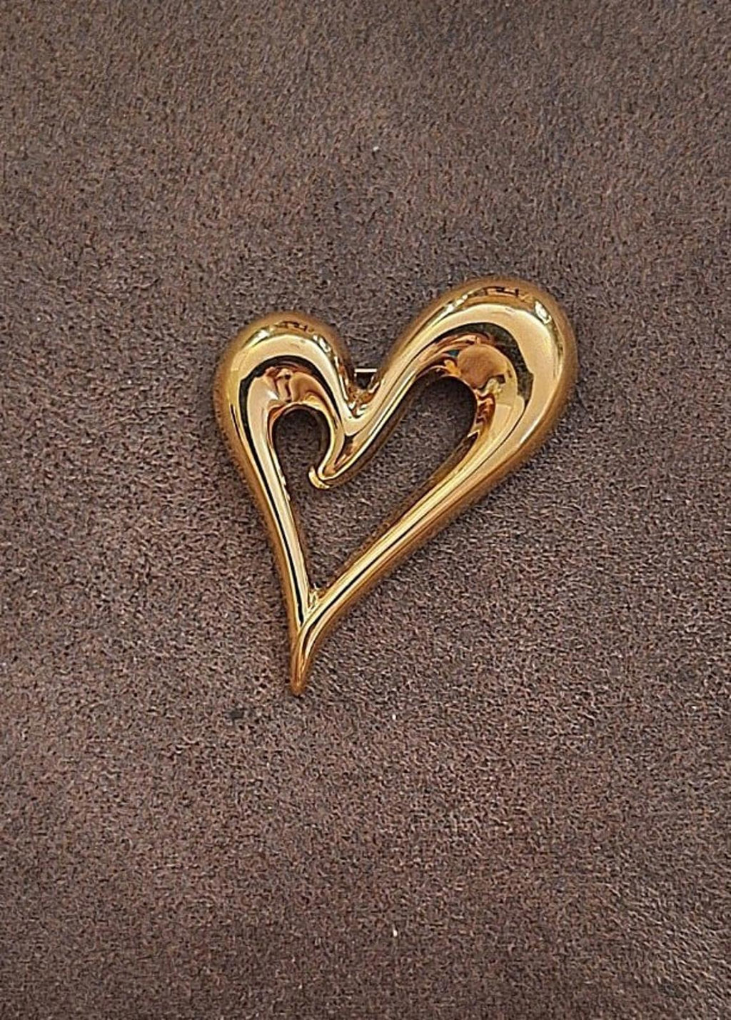 Gold heart-shaped pin with open center and shiny raised contour