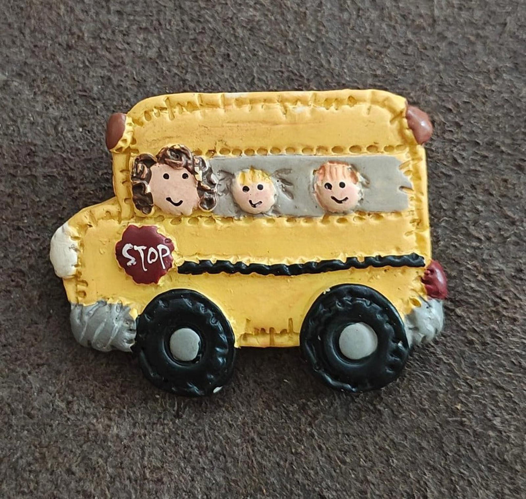 Yellow school bus resin pin front view with cartoon children and red STOP sign