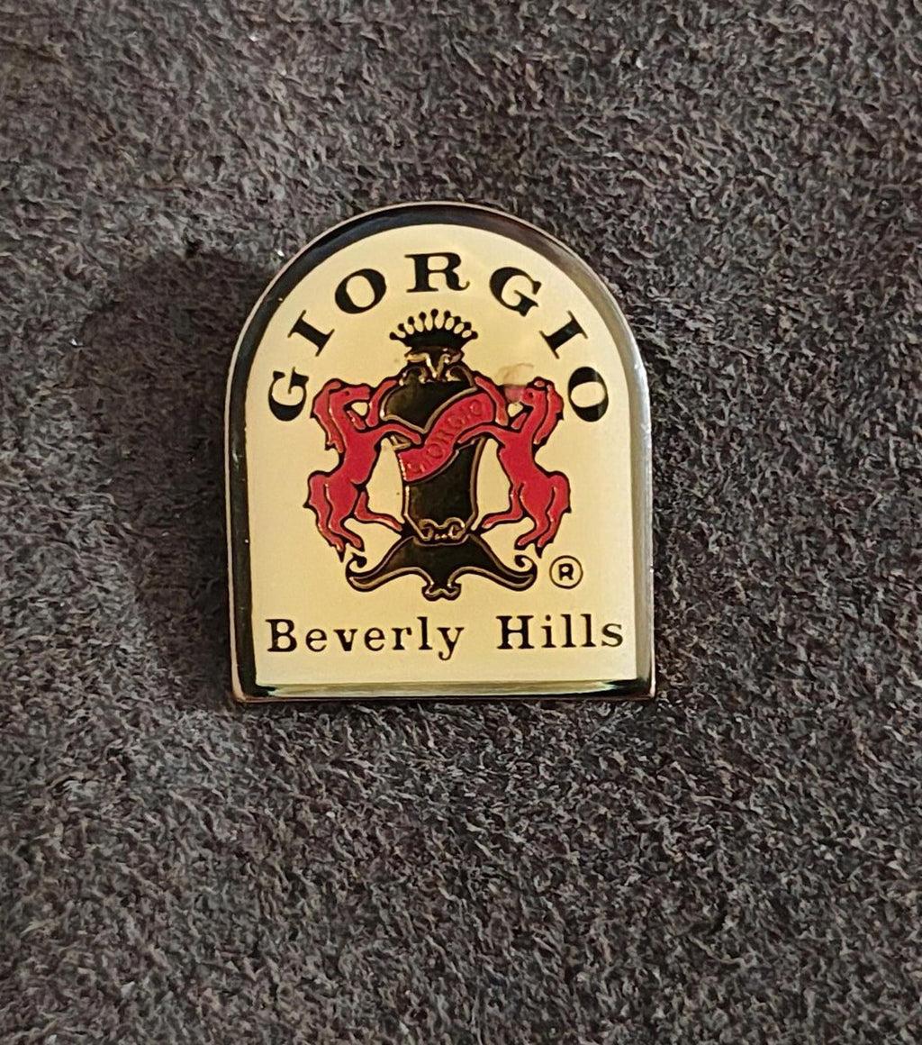 Gold-tone enamel badge pin featuring a red and black lion crest and "Beverly Hills"