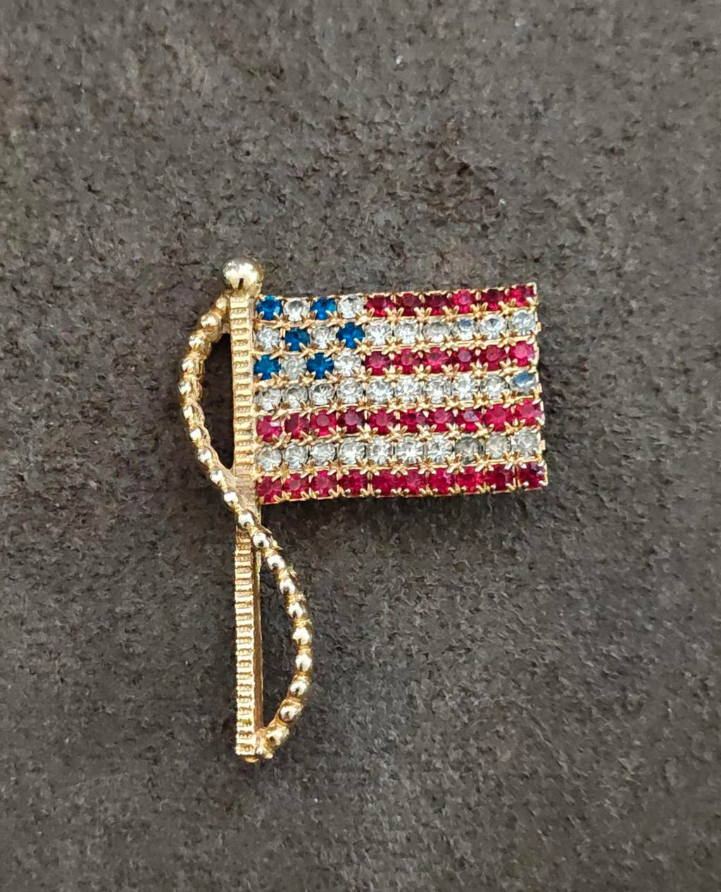 Gold-tone American flag rhinestone pin brooch with red, white, and blue stars
