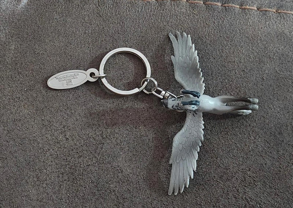 Gray Buckbeak keychain with wings spread and metal ring on oval charm