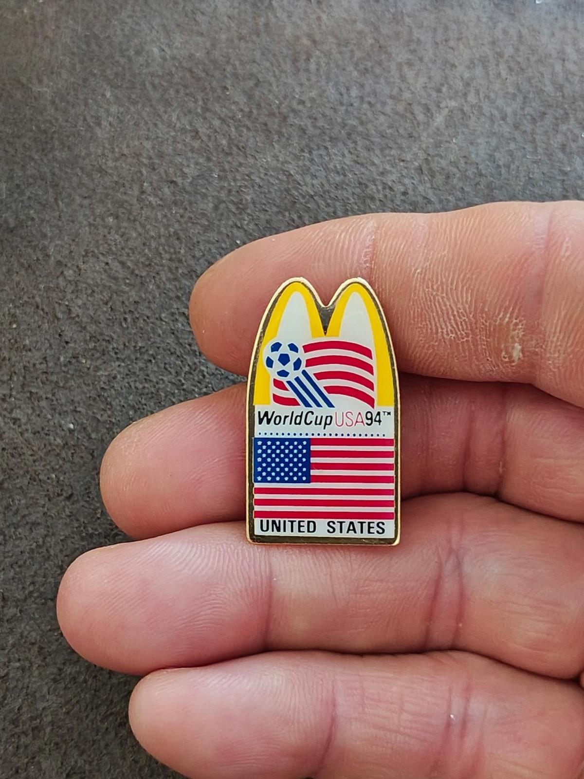 Gold-tone McDonald's WorldCup USA '94 lapel pin with soccer globe and U.S. flag