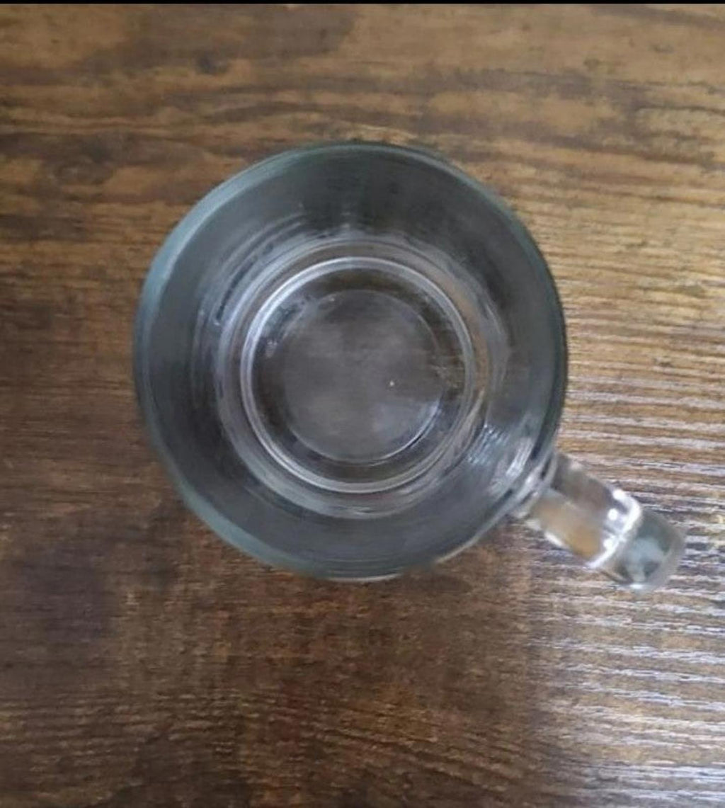 Clear glass mug bottom view with empty interior visible through the base