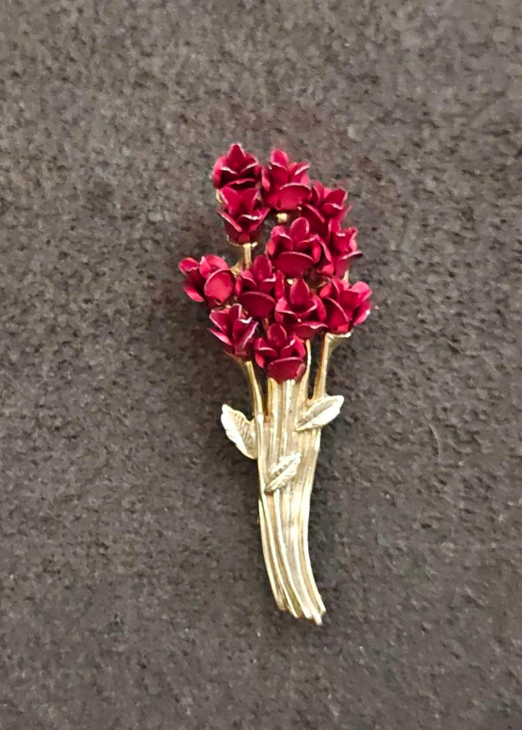 Gold tone rose bouquet brooch with dense red rose cluster top and gold leaves
