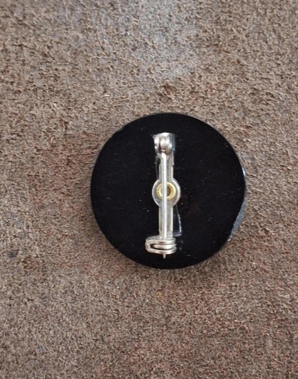 Black cameo brooch back view with silver pin and hinge clasp