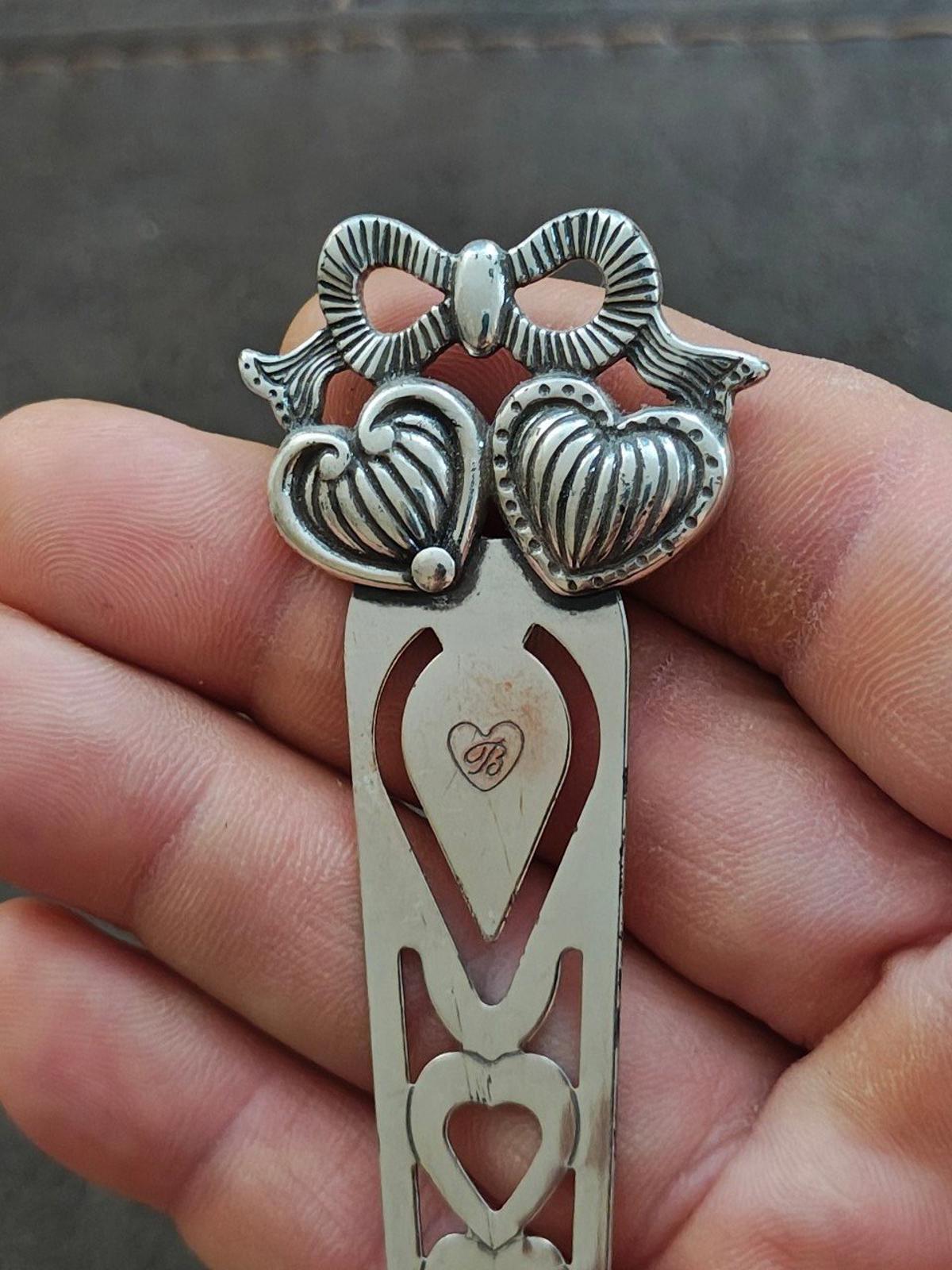 Silver plated letter opener bookmark with heart cutouts and etched shield medallion