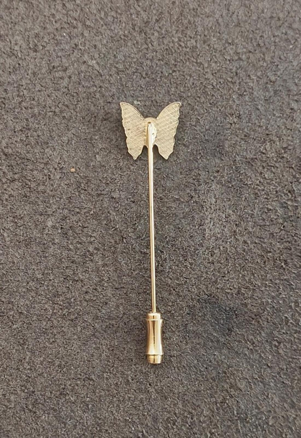 Gold tone butterfly stick pin with beige enamel wings and long straight post