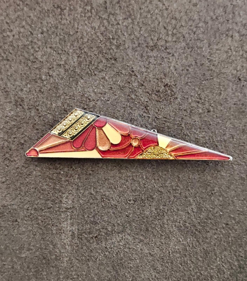 Art deco geometric enamel brooch with red center fan, gold details, and silver-tone edges