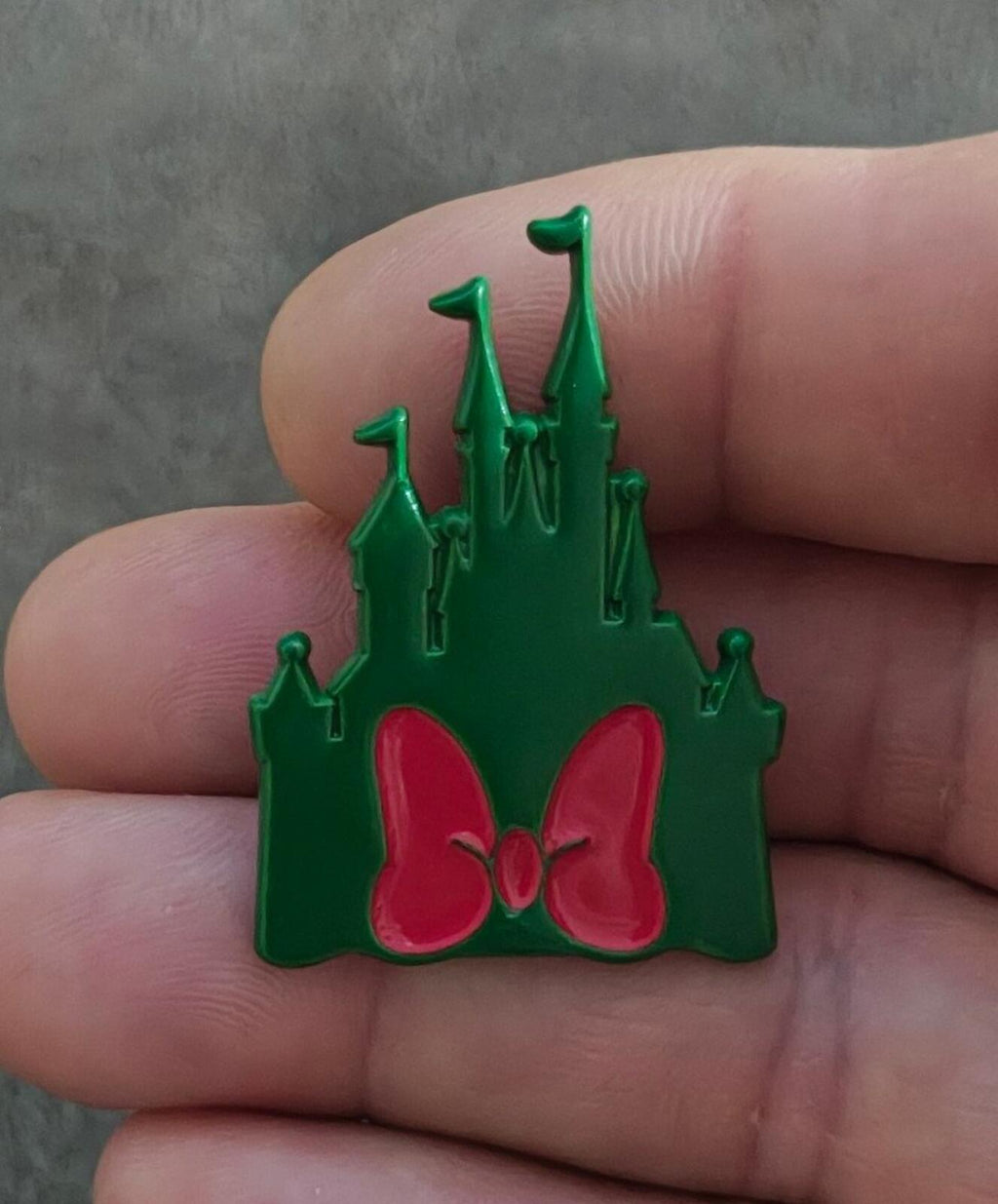 Green castle enamel pin with three spires and pink bow center detail