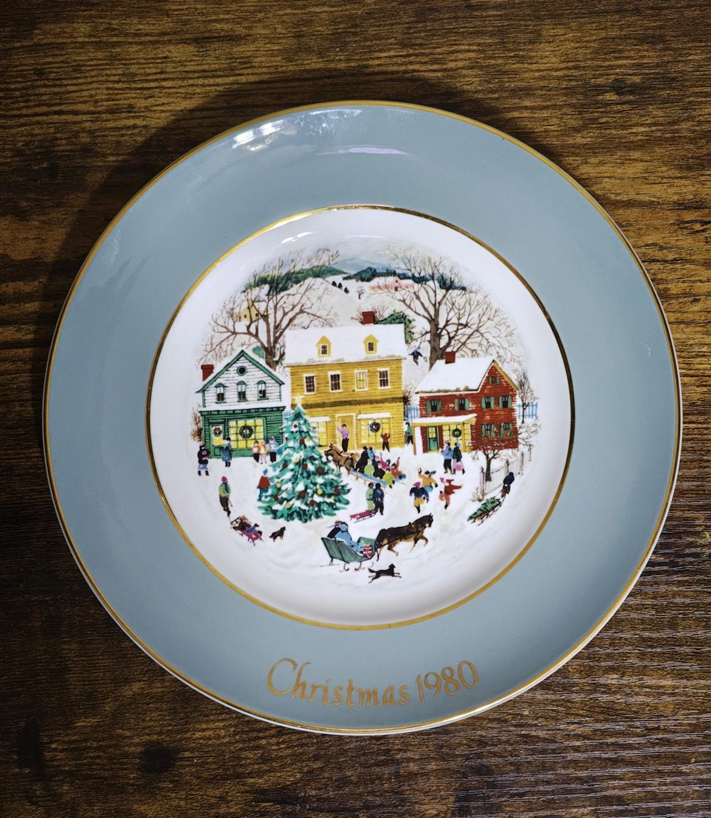Light blue Avon Country Christmas porcelain plate with 1980 winter village artwork and gold rim