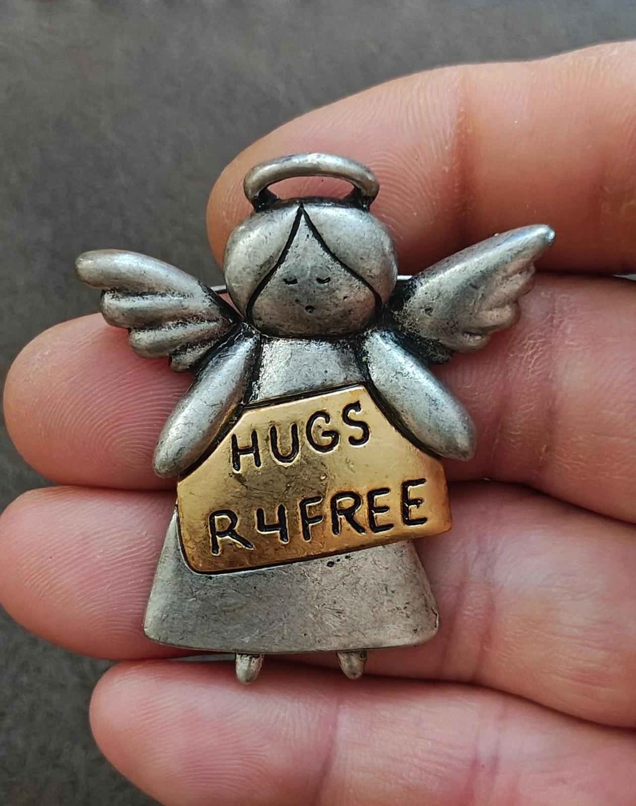Silver tone angel pin brooch close-up with top loop and wings; HUGS R4FREE