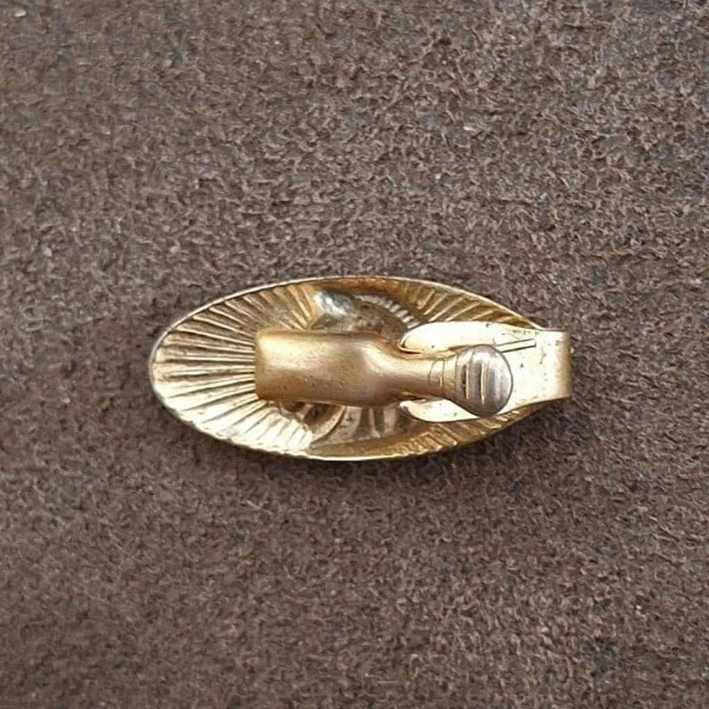 Gold-tone oval tie bar clip back view with smooth bar and clasp groove