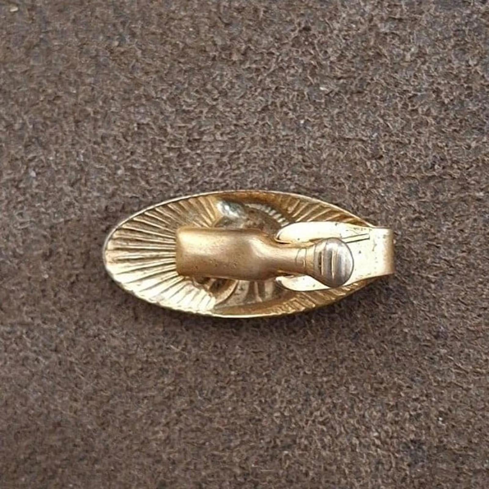 Gold-tone oval tie bar clip back view with smooth bar and clasp groove