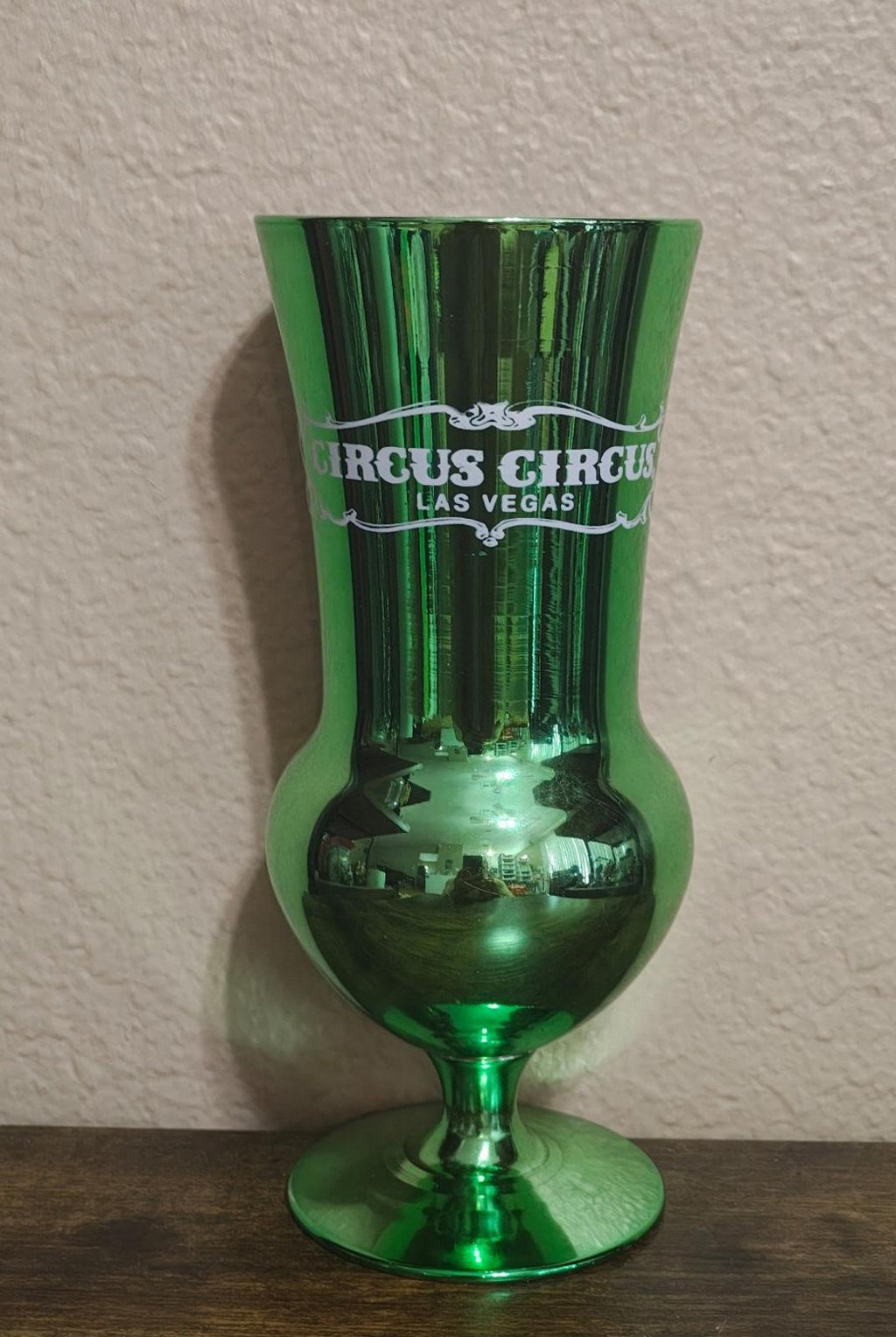 Green mirrored hurricane glass with Circus Circus Las Vegas logo, flared rim.