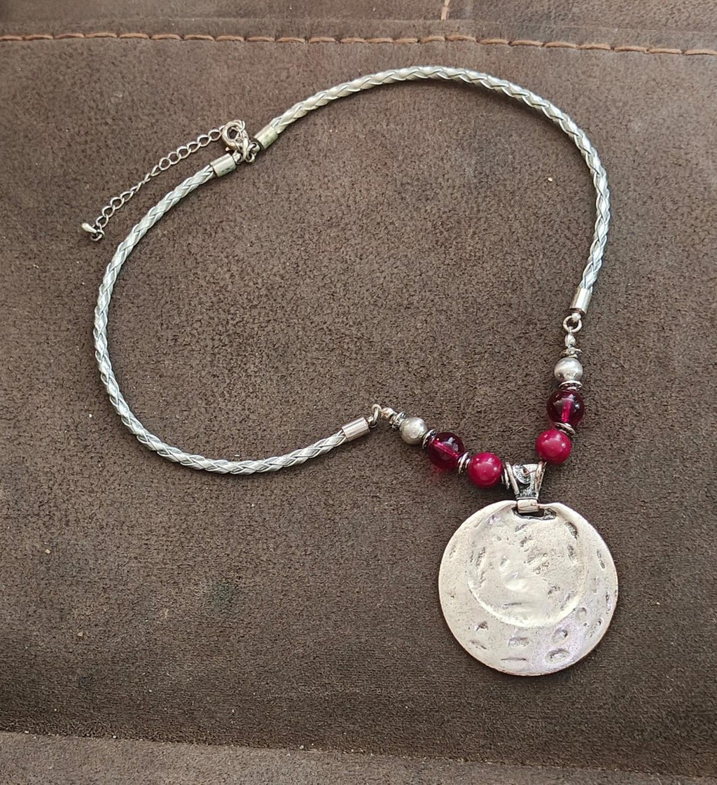 Silver-tone chain necklace with round burgundy pendant disc and pink bead detail