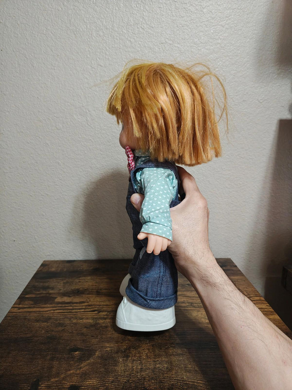 Boy collectible doll back view, denim overalls with suspenders, blue dot shirt and blonde hair.