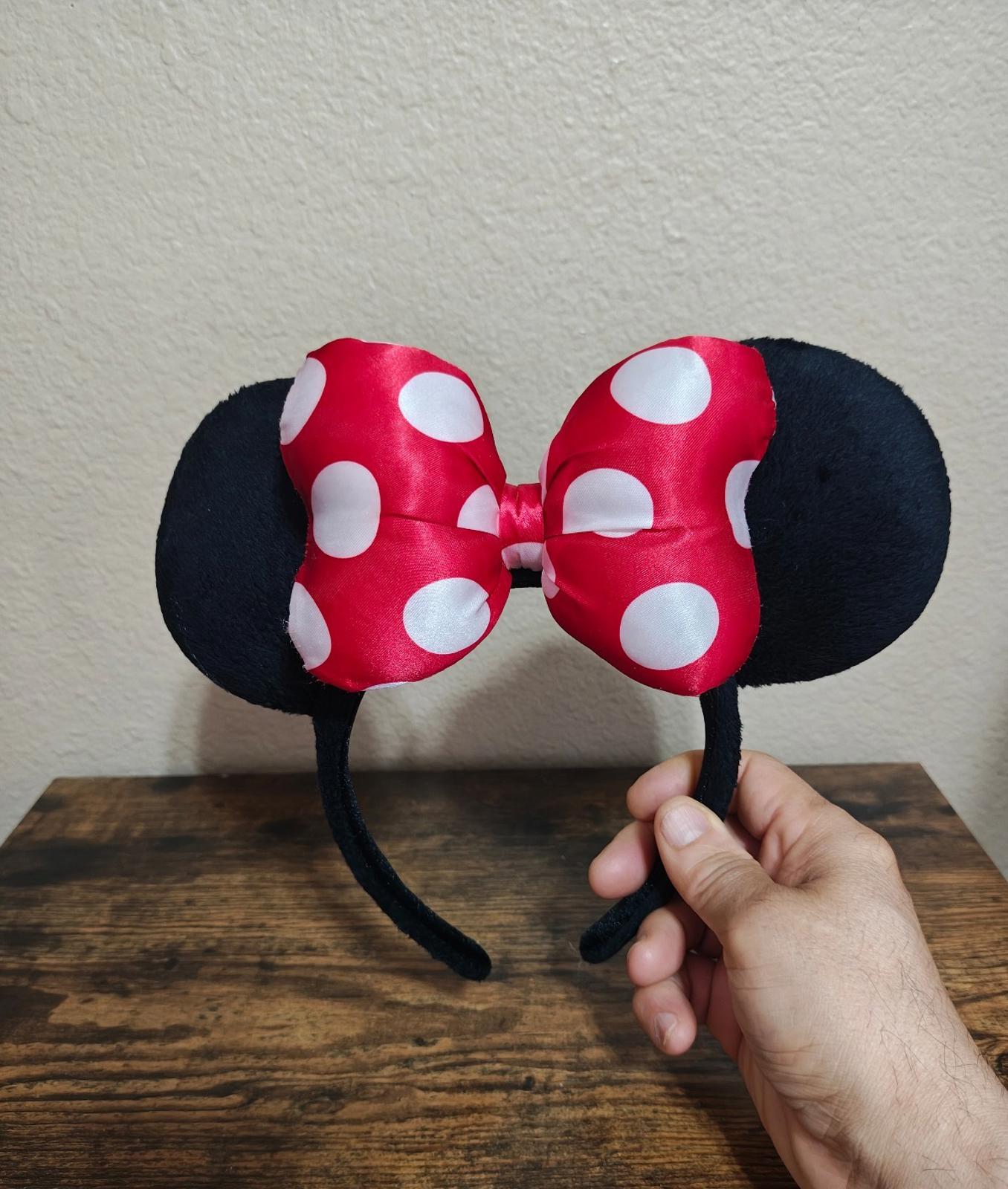 Red and white polka-dot bow ear headband with black fabric ears