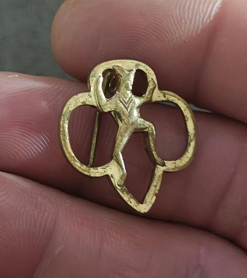 Gold-tone Girl Scout Brownie membership pin brooch with raised silhouette on front